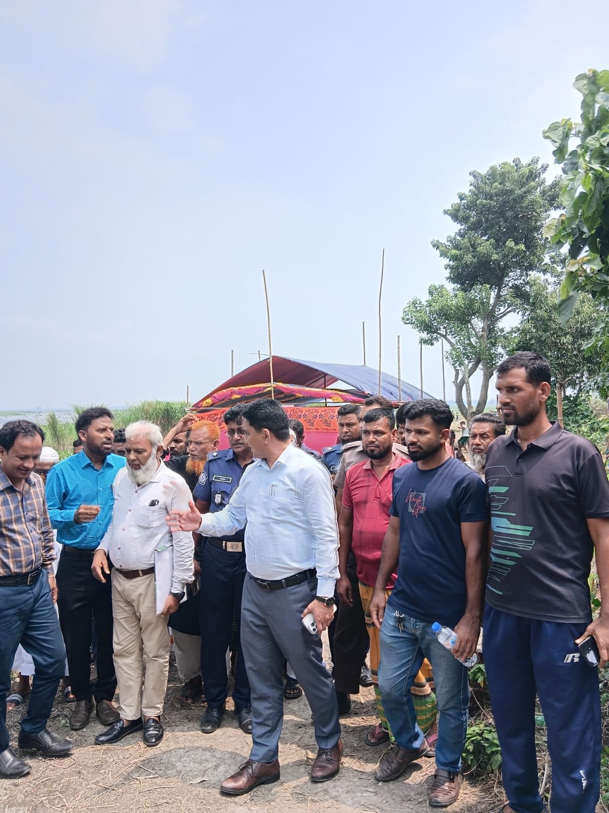 Field visit; group standing outdoors.